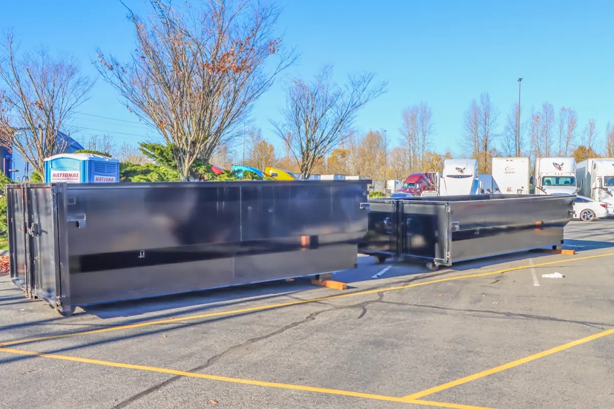Professional dumpster rental service with roll-off container on residential driveway in Sienna